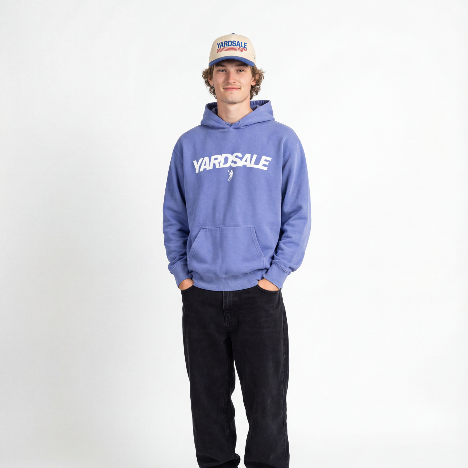 Person wearing a blue 'Yardsale' hoodie and black pants on a white background