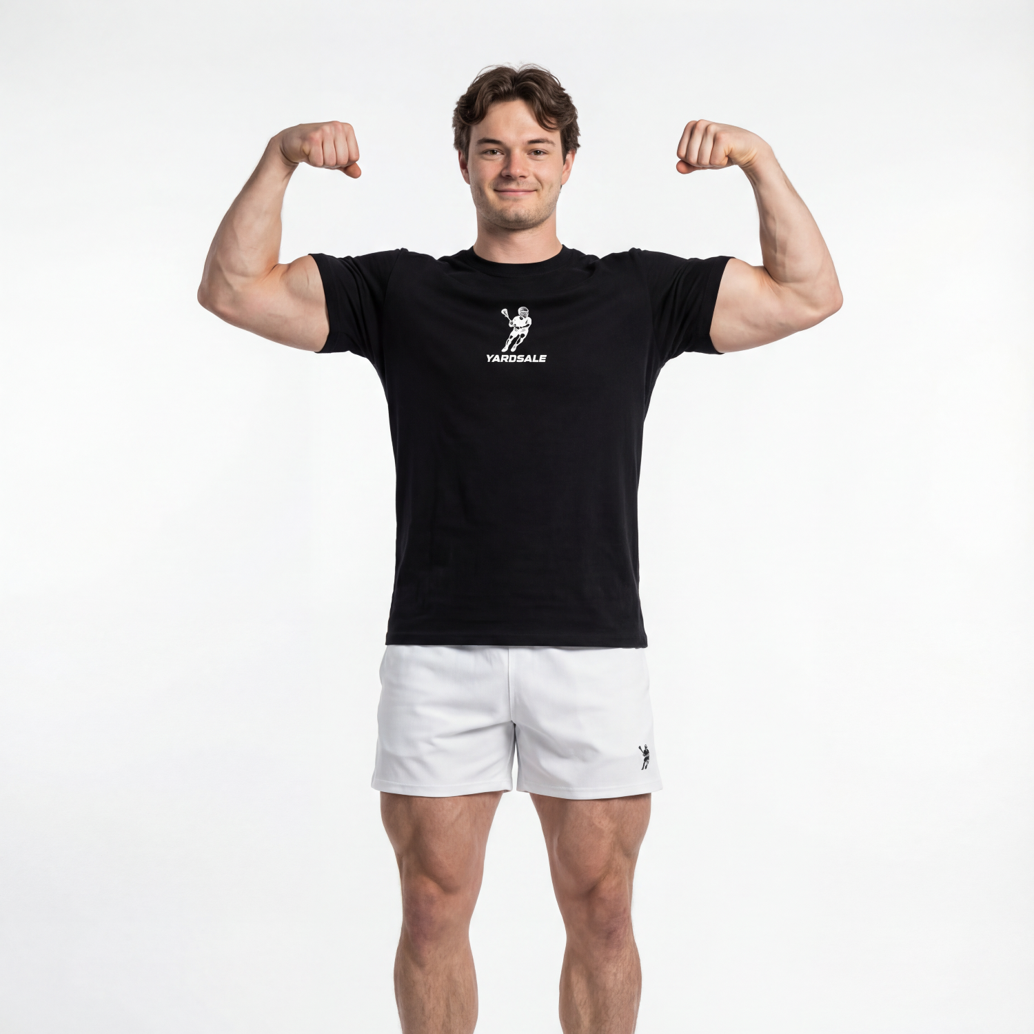 Man flexing muscles wearing a black t-shirt and white shorts on a white background