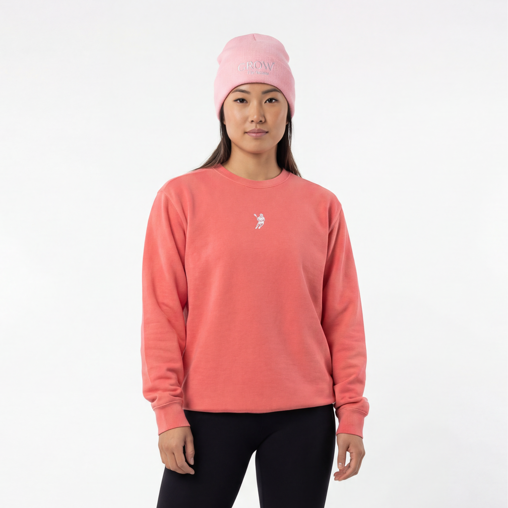 Person wearing a pink sweatshirt, black leggings, and white sneakers on a white background
