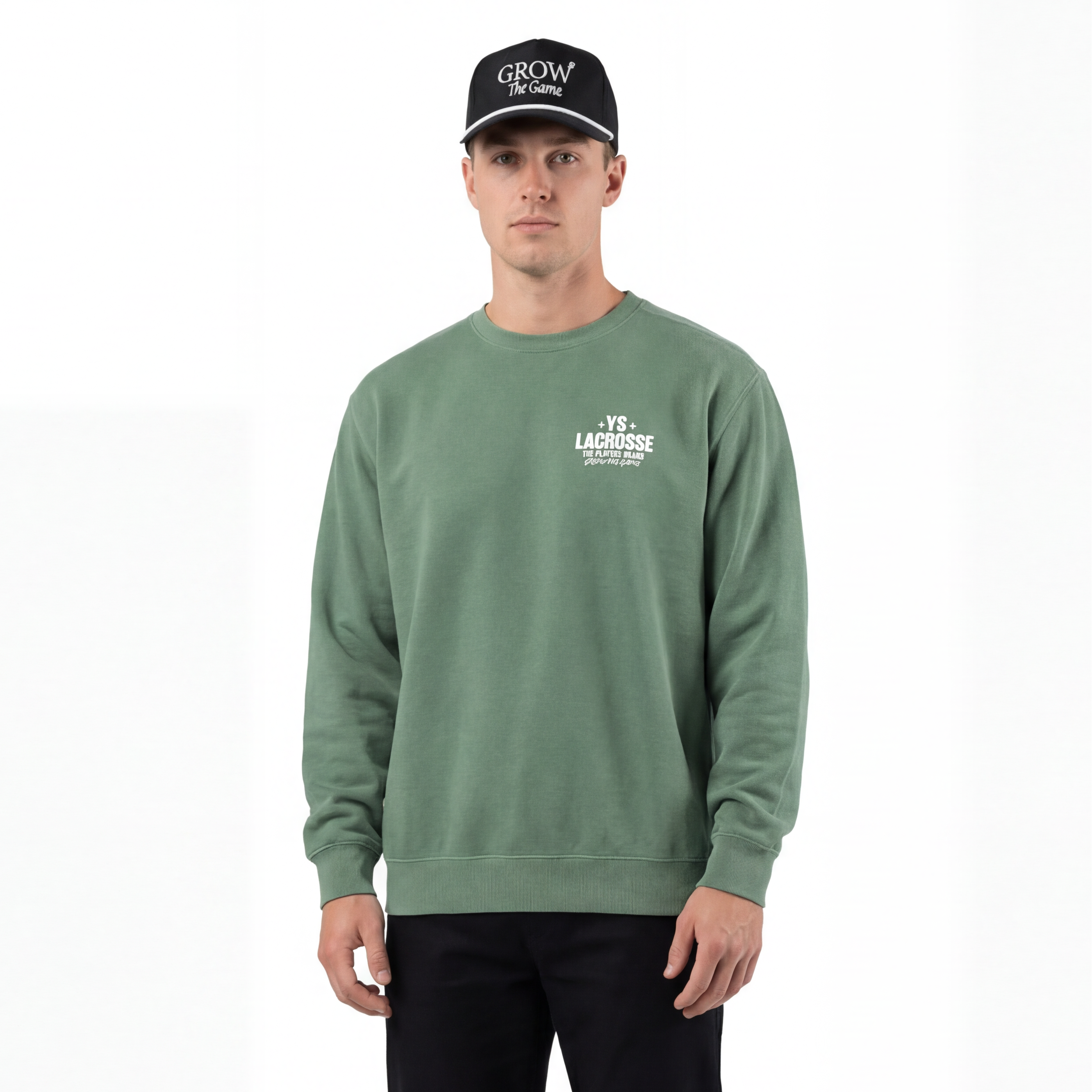 Man wearing a green sweatshirt with a logo, black pants, and a black cap on a white background