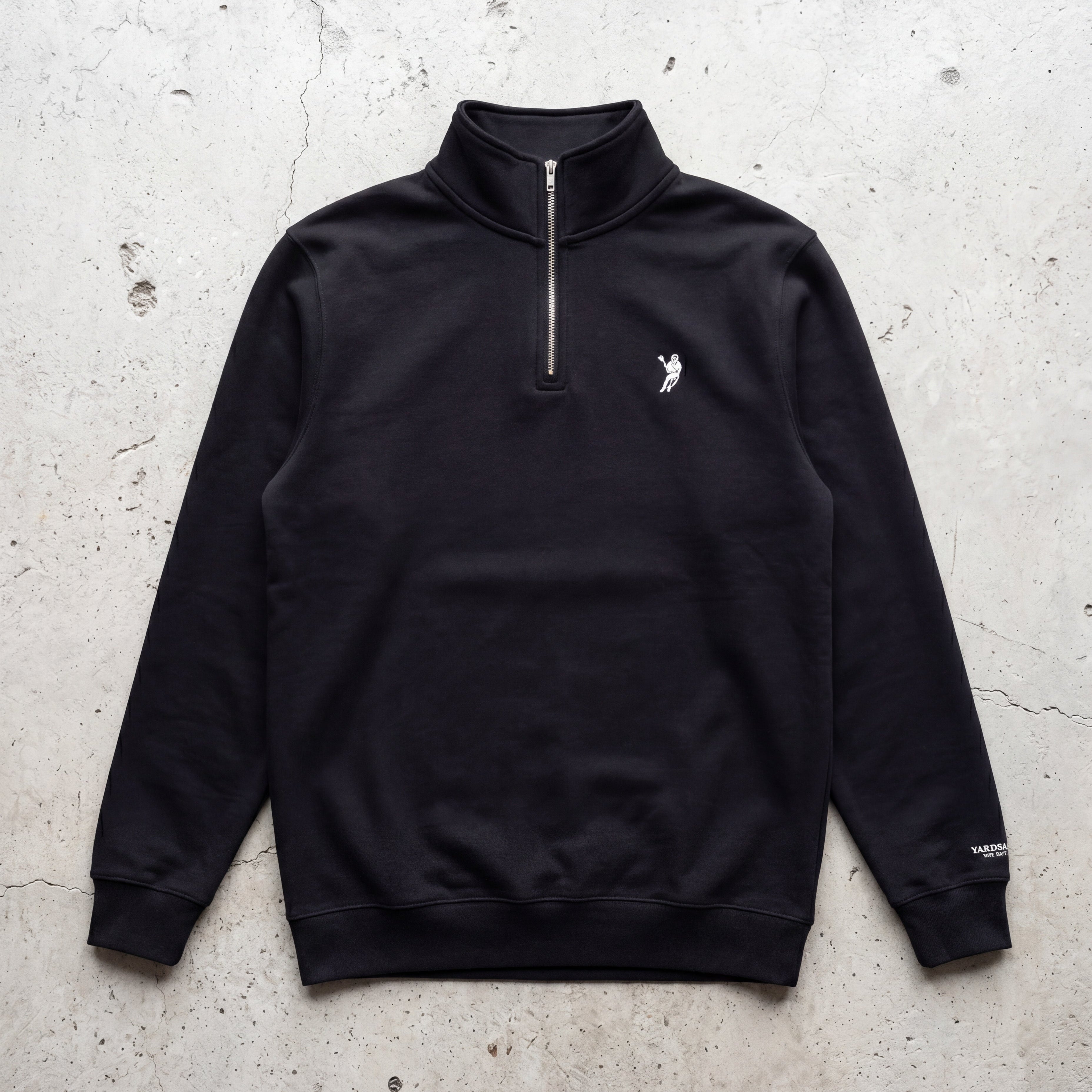Black quarter-zip sweatshirt with a logo on a textured light gray background